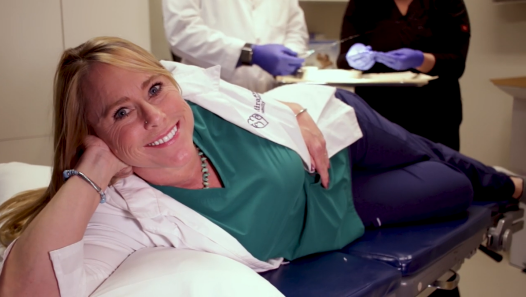 medical assistant, Jodi laying on exam table prepping for Biote procedure