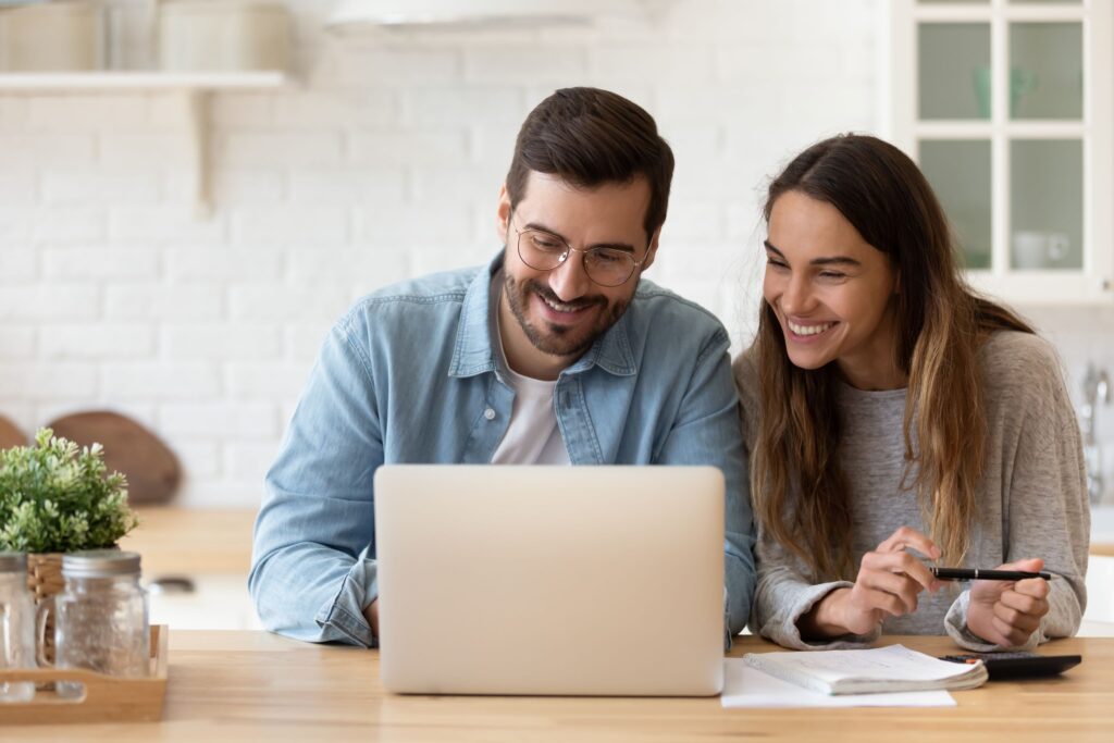 Direct Health by Miramont Open Enrollment man-woman-happy-looking-at-computer