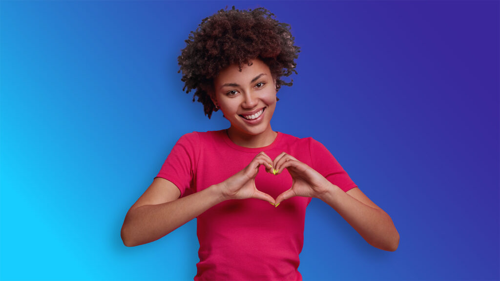 woman holding heart hand symbol over heart womens heart week 2025