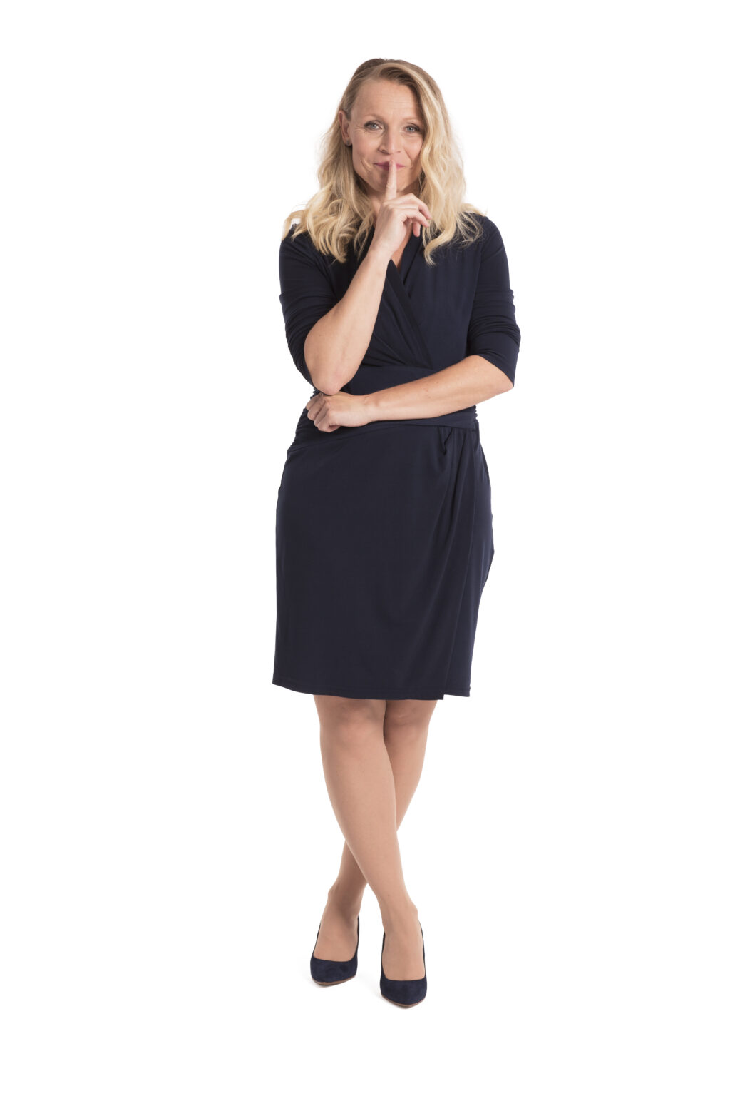 Emsella Model Incontinence Woman standing crossing her legs and holding her finger up to her mouth.