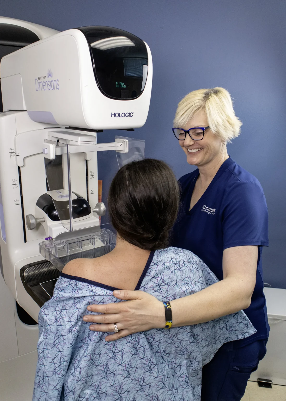 Miramont Wellness Centers Mammo Tech stands at 3d Mammography machine with a patient
