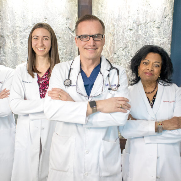Group of Miramont Clinicians standing smiling with their arms crossed.