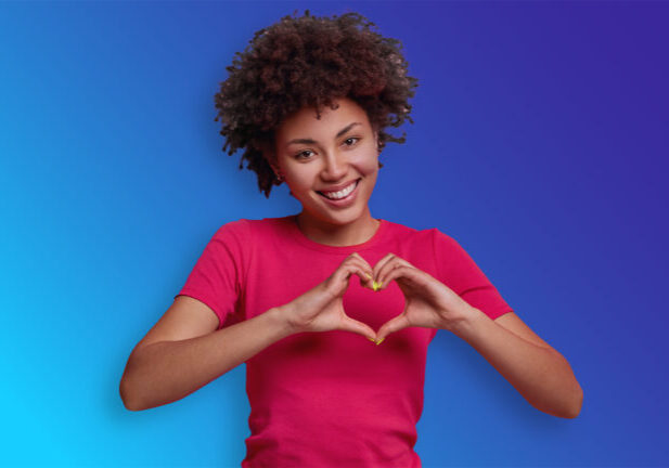 woman holding heart hand symbol over heart womens heart week 2025